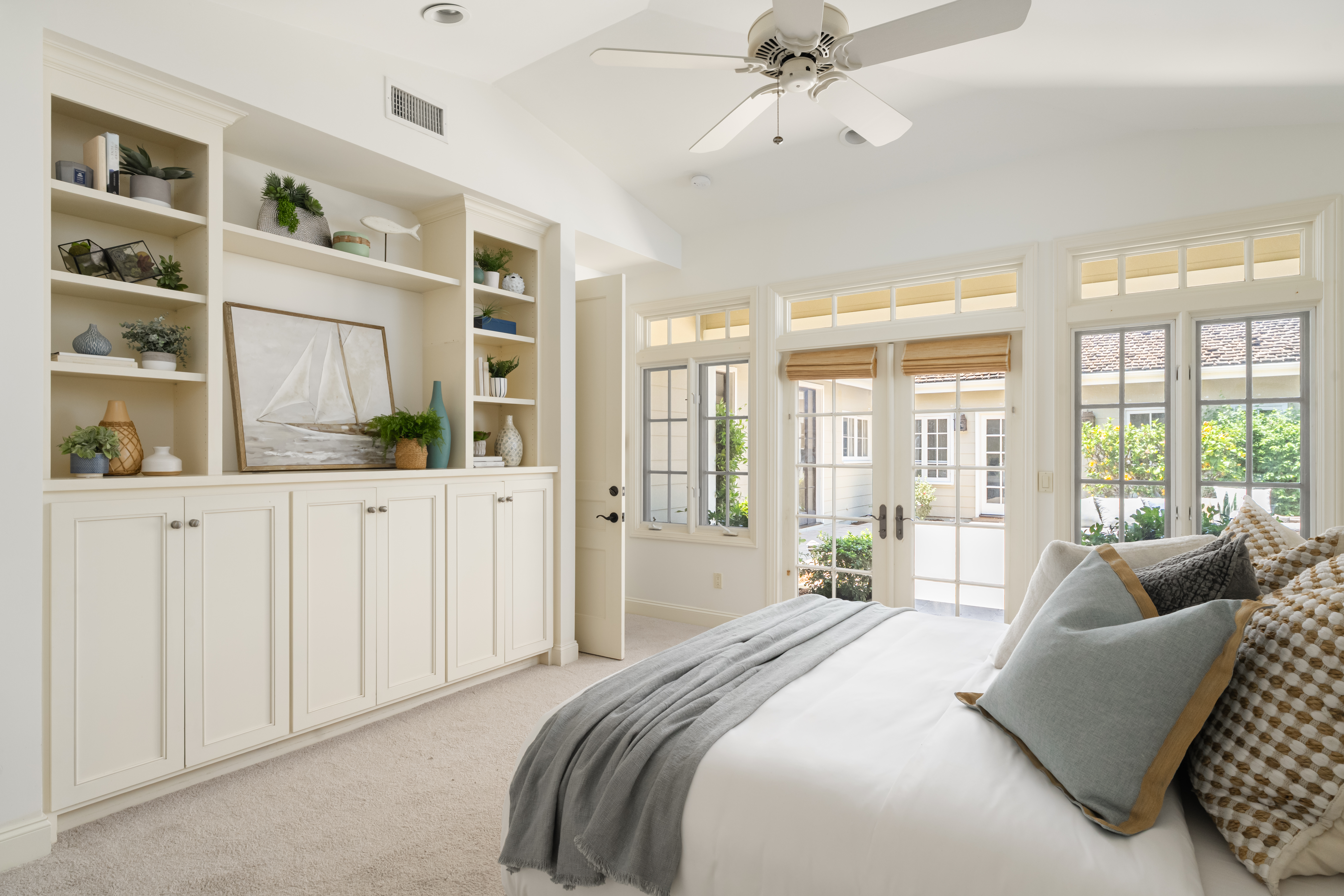 Home staging La Jolla bedroom built-in shelving French doors