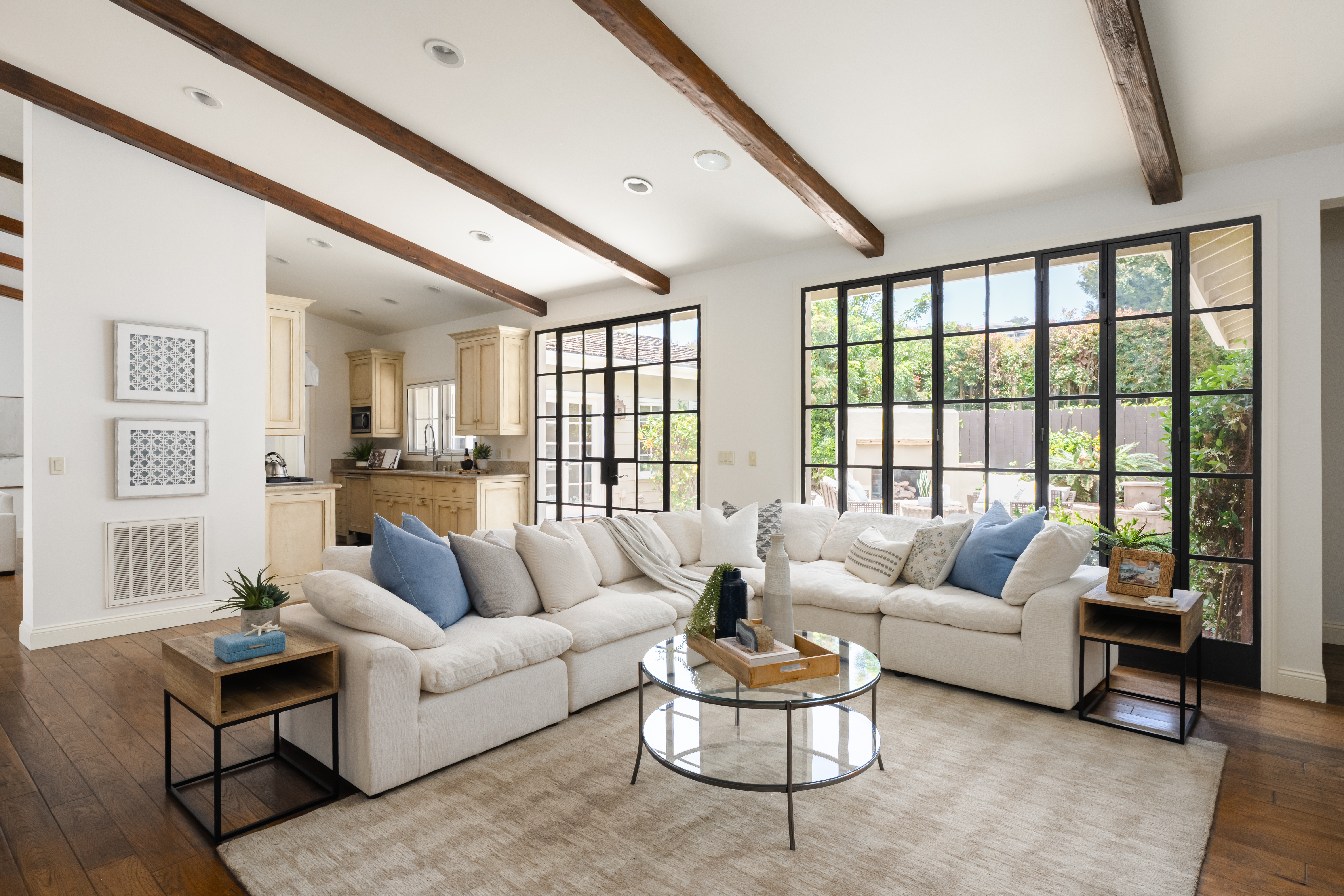 Staged living room La Jolla home staging steel windows wood beams
