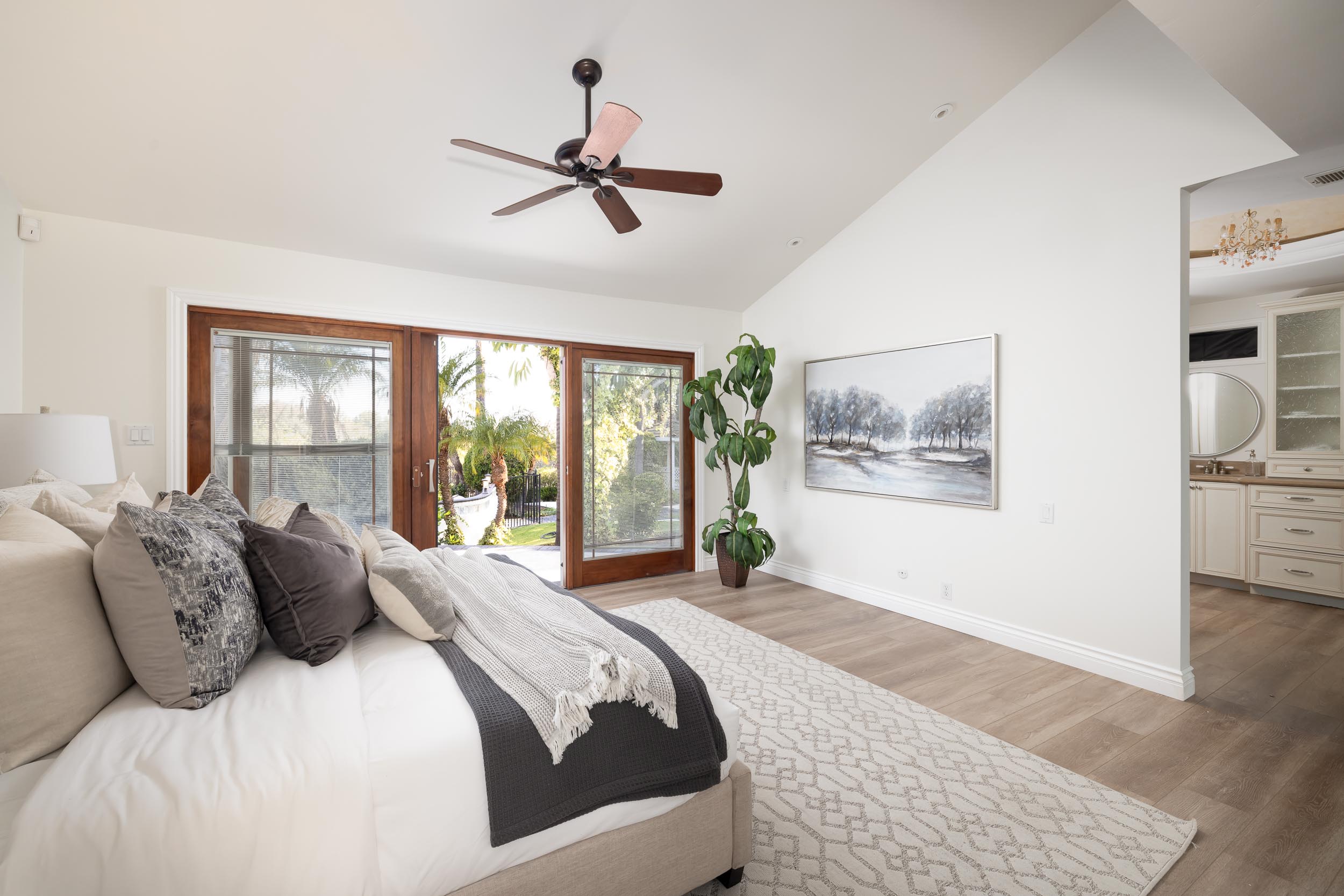 Staged primary bedroom French doors garden view Poway